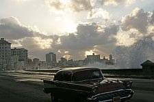 When the wind is strong, a few meters high waves fall upon the road. The coastline is the walking zone for tourists and locals, a place for morning runs, a meeting place of  street musicians, children and freelance artists. Habana, Cuba, Sunday, March 18, 2007.