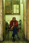 An old man sitting in the doorway of his room. Habana, Cuba, Friday, Feb. 23, 2007. A beautiful building of a former convent was turned into an old people’s home in 1965. Old people without families and those who are unable to move live here permanently. The rest come for breakfast and return home for the night. Every week elderly people hold theatre shows or recitals, where guest artist or inhabitants themselves perform.