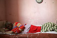 A woman sleeping in her room. Habana, Cuba, Friday, Feb. 23, 2007. A beautiful building of a former convent was turned into an old people’s home in 1965. Old people without families and those who are unable to move live here permanently. The rest come for breakfast and return home for the night. Every week elderly people hold theatre shows or recitals, where guest artist or inhabitants themselves perform.