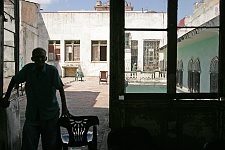 Sun-lit verandah. Habana, Cuba, Friday, Feb. 23, 2007. A beautiful building of a former convent was turned into an old people’s home in 1965. Old people without families and those who are unable to move live here permanently. The rest come for breakfast and return home for the night. Every week elderly people hold theatre shows or recitals, where guest artist or inhabitants themselves perform.