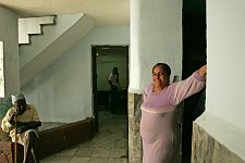 A woman and two workers. Habana, Cuba, Friday, Feb. 23, 2007. A beautiful building of a former convent was turned into an old people’s home in 1965. Old people without families and those who are unable to move live here permanently. The rest come for breakfast and return home for the night. Every week elderly people hold theatre shows or recitals, where guest artist or inhabitants themselves perform.