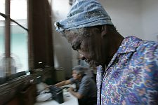 Old people’s home residents. Habana, Cuba, Sunday, Feb. 25, 2007. A beautiful building of a former convent was turned into an old people’s home in 1965. Old people without families and those who are unable to move live here permanently. The rest come for breakfast and return home for the night. Every week elderly people hold theatre shows or recitals, where guest artist or inhabitants themselves perform.