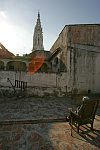Sun-lit verandah facing a church. Habana, Cuba, Sunday, Feb. 25, 2007. A beautiful building of a former convent was turned into an old people’s home in 1965. Old people without families and those who are unable to move live here permanently. The rest come for breakfast and return home for the night. Every week elderly people hold theatre shows or recitals, where guest artist or inhabitants themselves perform.