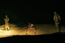 Military men check the documents and question an elderly Cuban man who is found at the beach in the evening. As a result of poor technical equipment the check can take up to a few hours, as the information is transmitted to an own base and then to Havana. Then the response is expected. Not far from an U.S. Naval Base Guantanamo. Guantanamo, Cuba, Saturday, March 3, 2007.