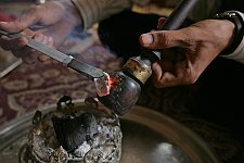 Smoking opium in a private house in the town of Bam, Iran on Thursday, April 27, 2006.The town seriously damaged by an earthquake has become a transit center for drugs supplied from Afghanistan and Pakistan and going further on west. It's no problem to purchase opium in the town. Smoking it is popular with the citizens as an evening relaxation easy of access.