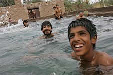 Swimming-pool in the town of Bam, Iran on Thursday, April 27, 2006. The small outdoor pool is the favorite rest-place both for children and grown-ups, naturally male persons only. One can wash himself and launder the linen here as well.