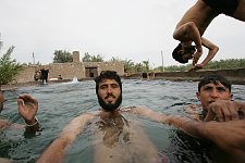 Swimming-pool in the town of Bam, Iran on Thursday, April 27, 2006. The small outdoor pool is the favorite rest-place both for children and grown-ups, naturally male persons only. One can wash himself and launder the linen here as well.