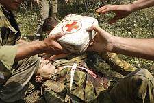A moment after the bombardment of the convoy by the Georgian aircraft on the road from Tshinvali to Russia. First aid being given to a wounded Russian soldier. Monday August 11, 2008. 