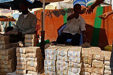 Street money changers at work. Hargeisa, SomaliLand, Saturday, September 29, 2007. The largest denomination bank note in the country - 500 shillings - is equal to 8 American cents. Besides it 100 and 50 shilling banknotes are in circulation as well.
