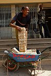 The wheelbarrow full of banknotes next to the bank entrance. Hargeisa, SomaliLand, Saturday, September 29, 2007. The largest denomination bank note in the country - 500 shillings - is equal to 8 American cents. Besides it 100 and 50 shilling banknotes are in circulation as well.