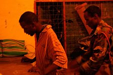 The policeman searching the suspect. Hargeisa, SomaliLand, Tuesday, October 9, 2007. The police station named New Hargeisa is situated in one of the most criminal districts of the capital with its largest market and railway terminal.