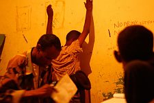 The policeman searching the suspect. Hargeisa, SomaliLand, Tuesday, October 9, 2007. The police station named New Hargeisa is situated in one of the most criminal districts of the capital with its largest market and railway terminal.